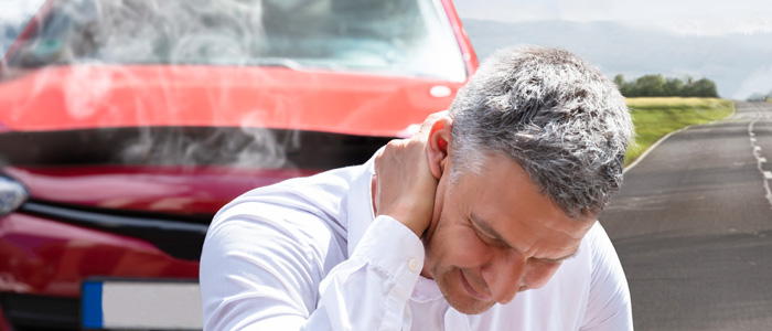 a photo of a guy with neck pain from auto injury